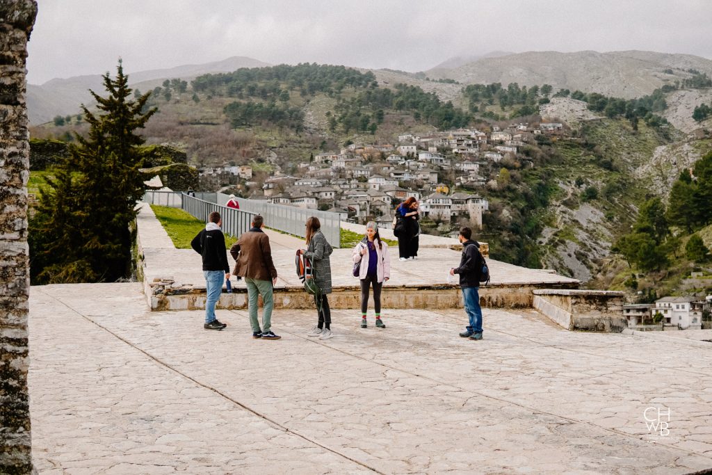 People looking out over a city in a mountainous landscape